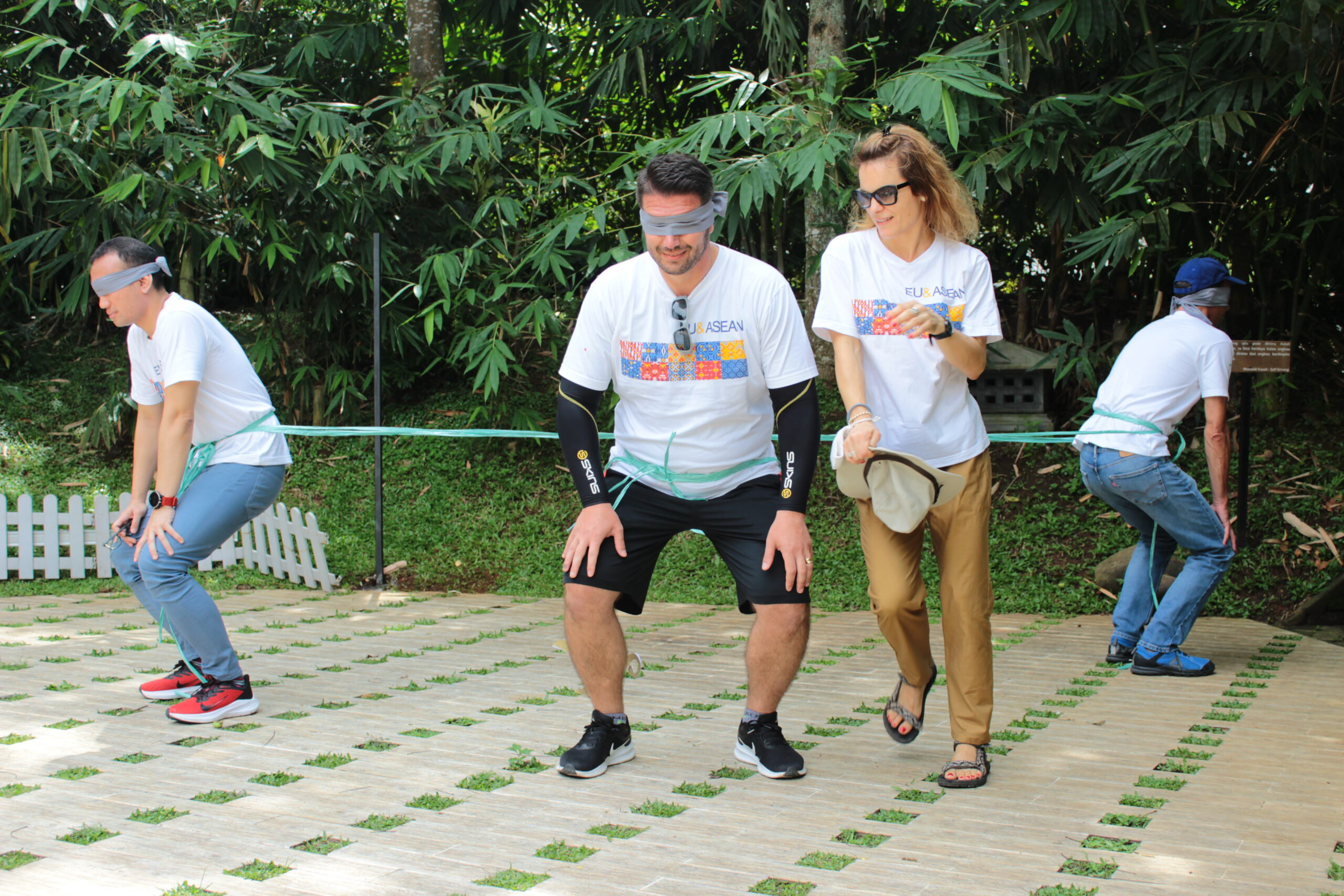 3 pria peserta games outing kantor Bumi Journey bermain Ladang Ranjau sambil mata mereka ditutup dan diarahkan oleh seorang peserta wanita