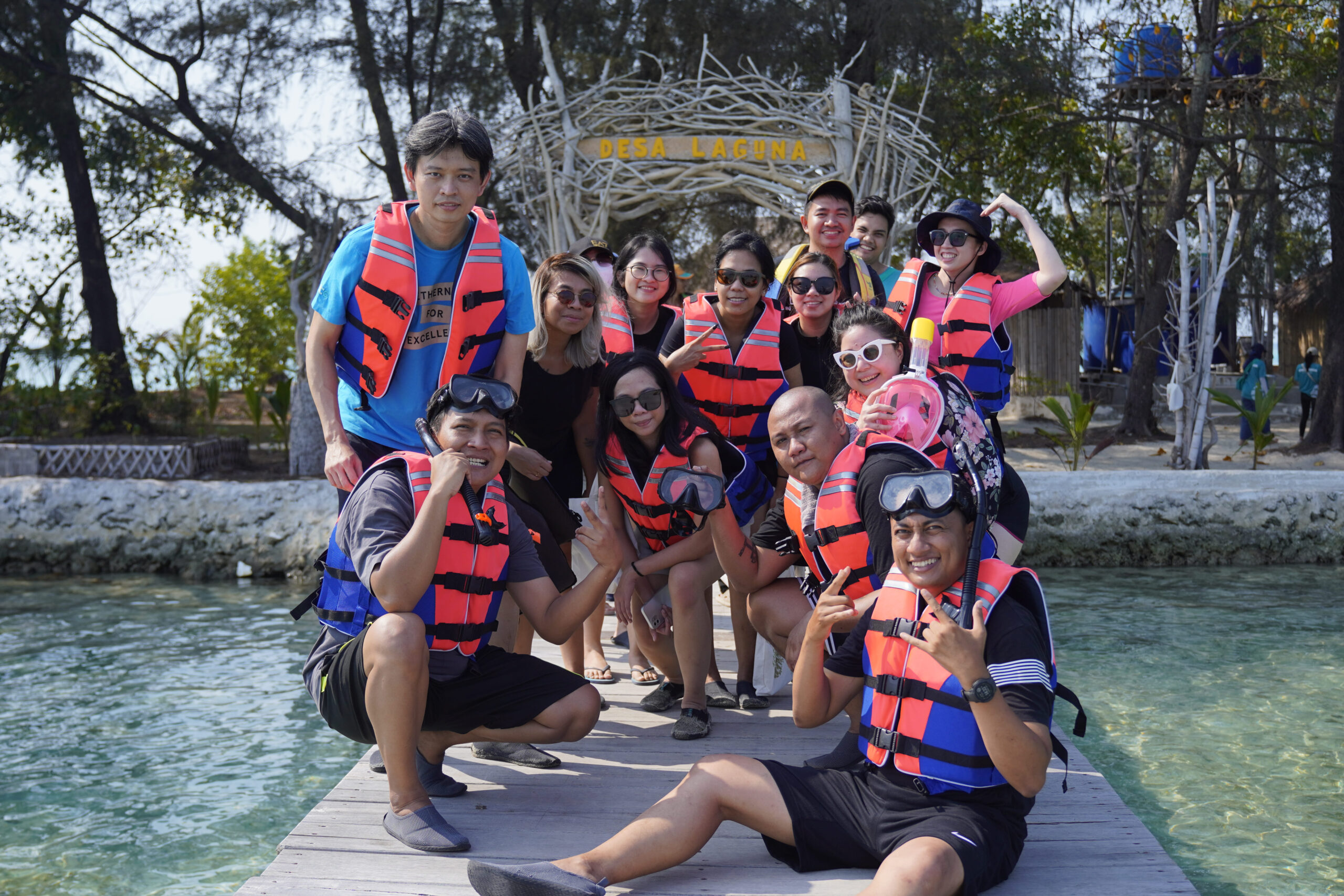 Sekelompok wisatawan dalam 1 grup berpose di atas dermaga pintu masuk Desa Laguna